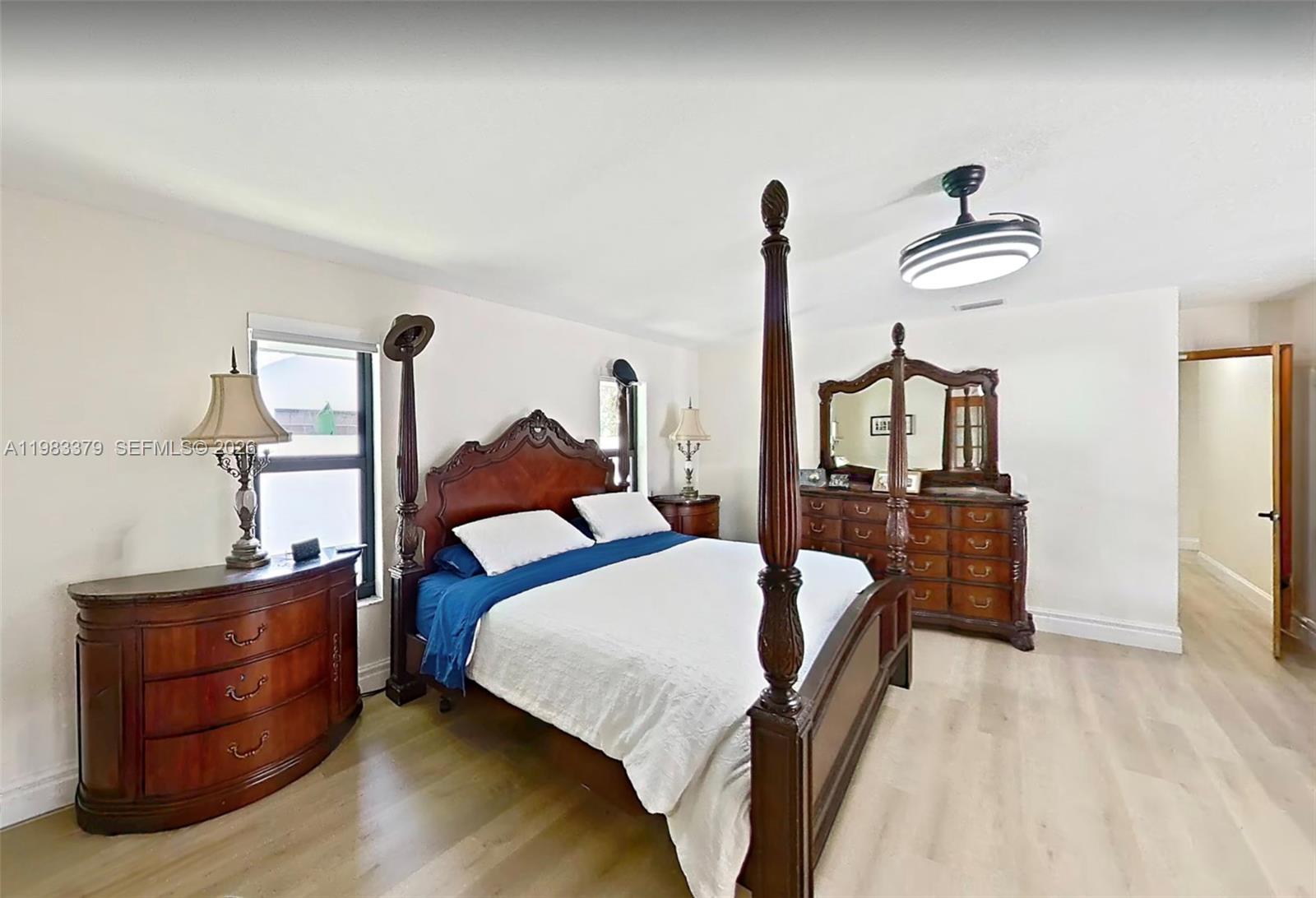 10320 Southwest 139th Street Miami, FL 33176 - Photo 26 of 100 a bedroom with a bed and wooden floor