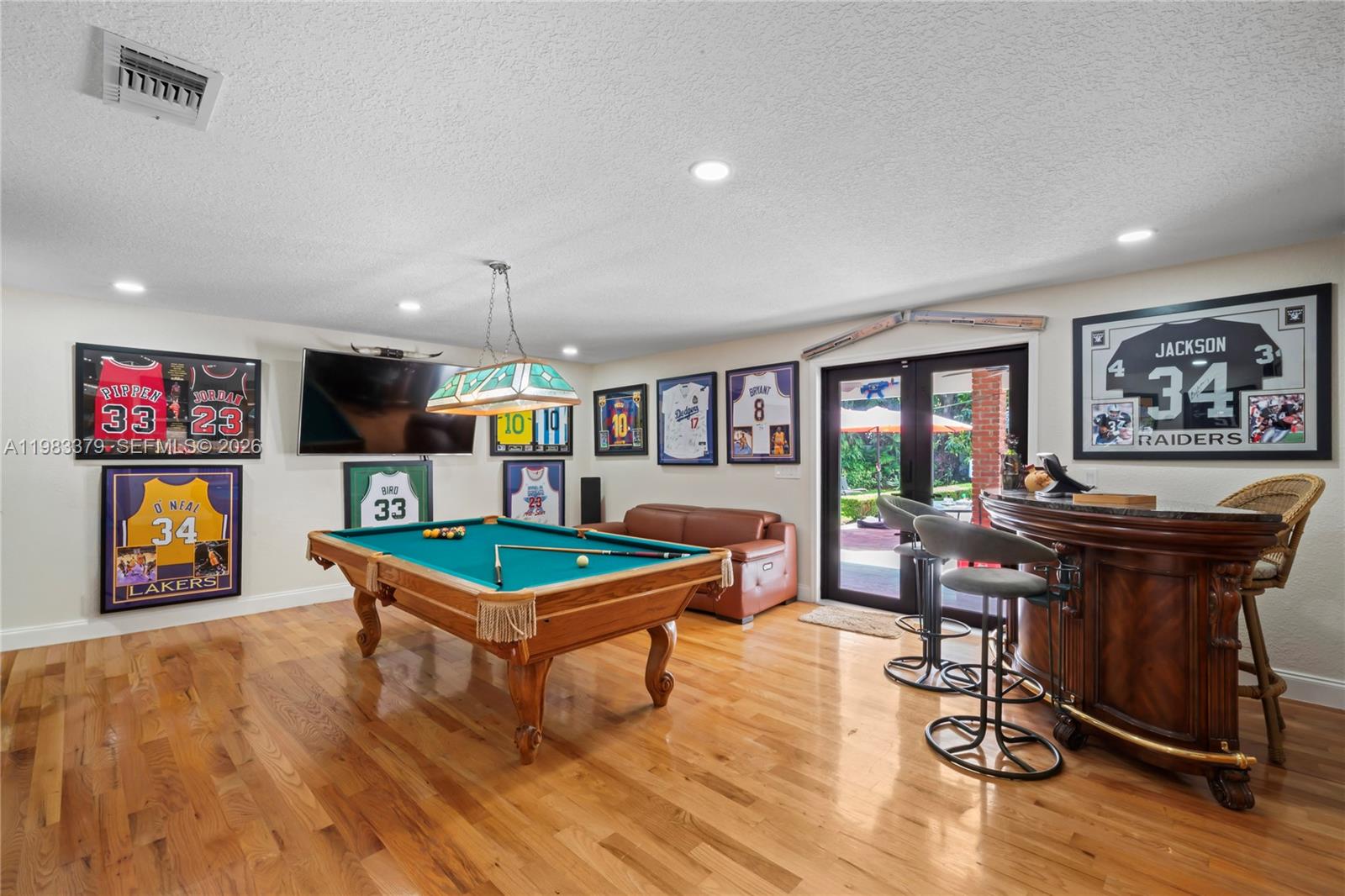 10320 Southwest 139th Street Miami, FL 33176 - Photo 43 of 100 a living room with furniture pool table and a flat screen tv