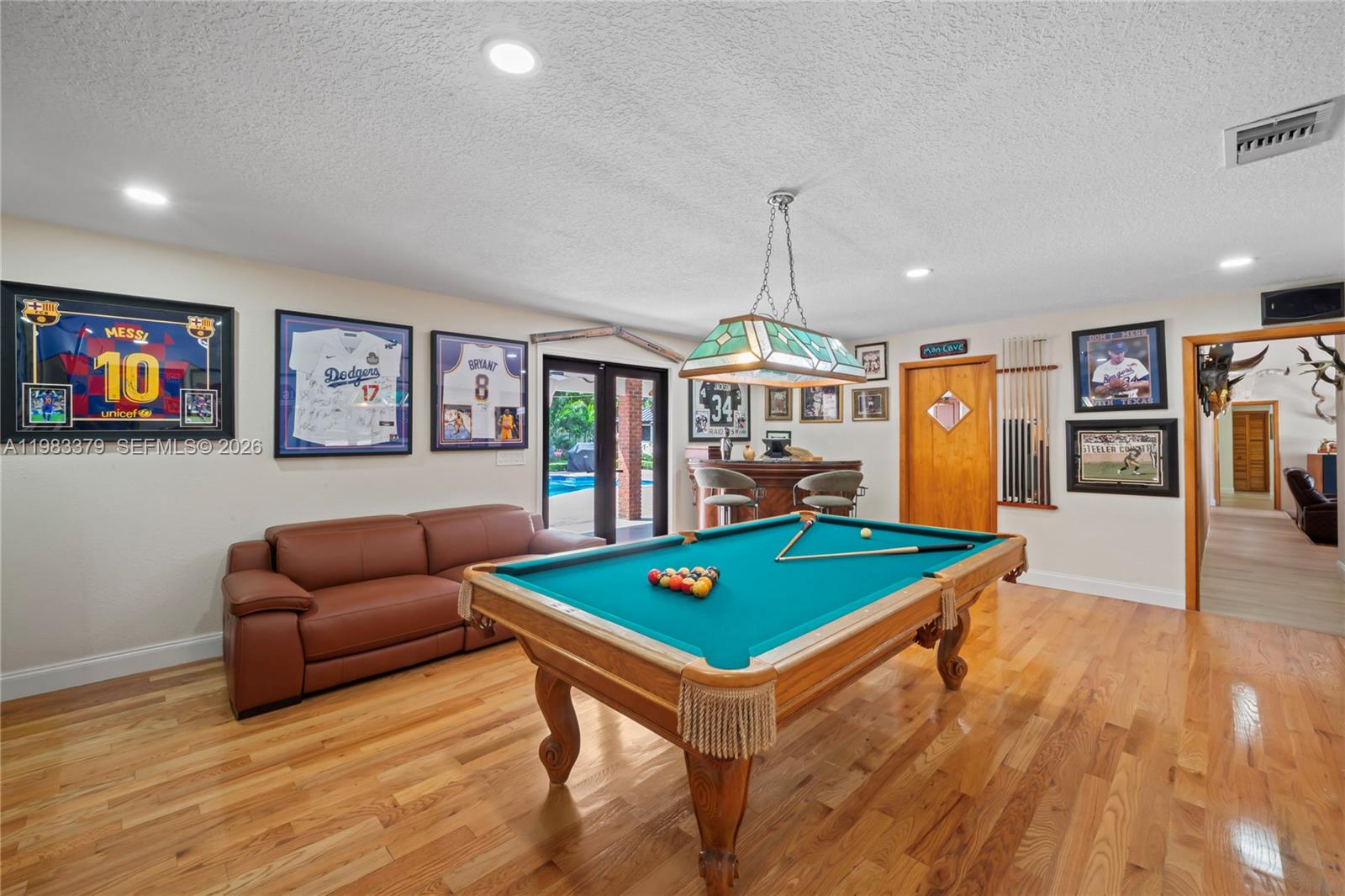 10320 Southwest 139th Street Miami, FL 33176 - Photo 44 of 100 a living room with furniture pool table and a flat screen tv