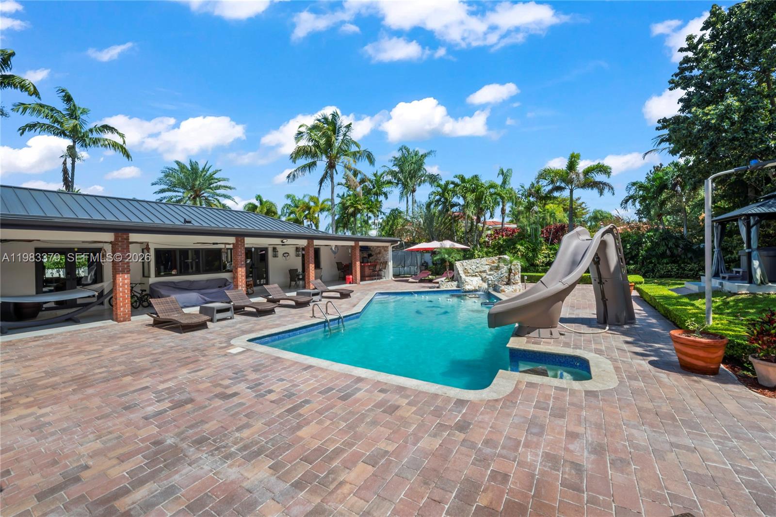 10320 Southwest 139th Street Miami, FL 33176 - Photo 6 of 100 a view of a house with backyard porch and sitting area