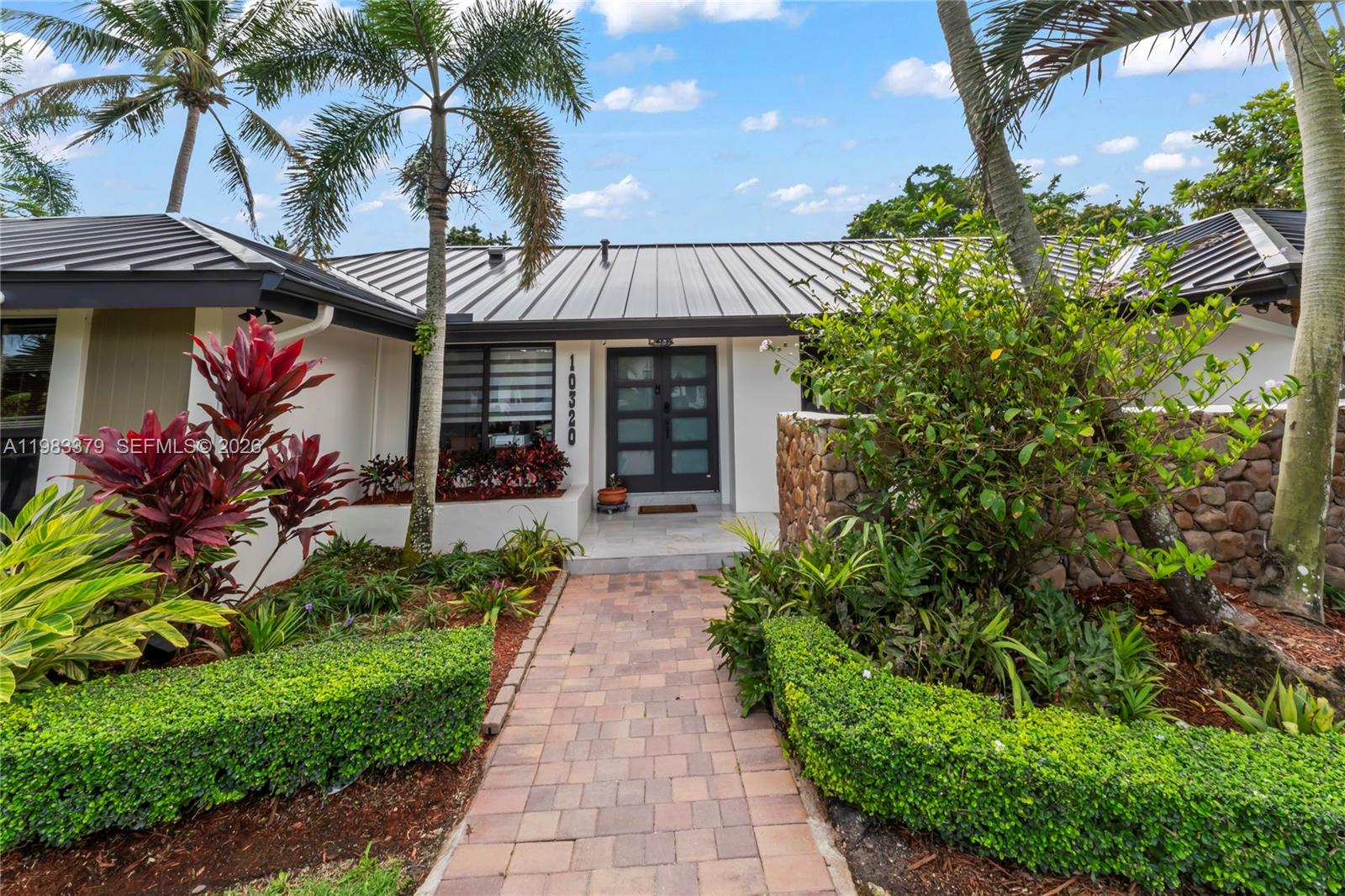 10320 Southwest 139th Street Miami, FL 33176 - Photo 69 of 100 a front view of a house with a porch