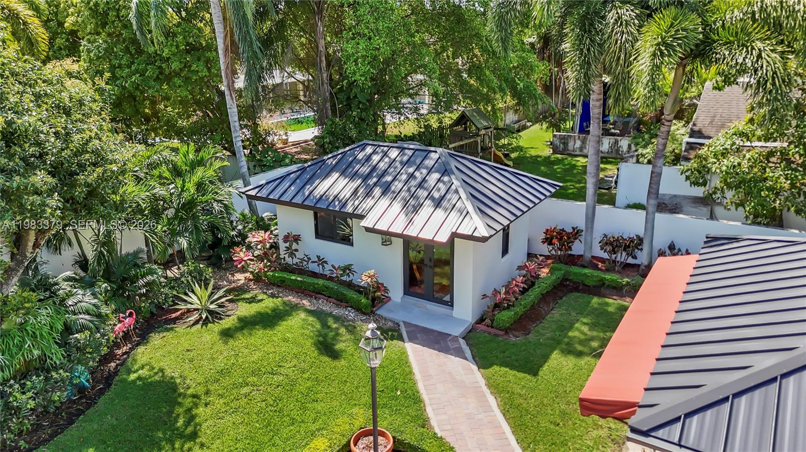 10320 Southwest 139th Street Miami, FL 33176 - Photo 76 of 100 a view of a house with a yard porch and sitting area