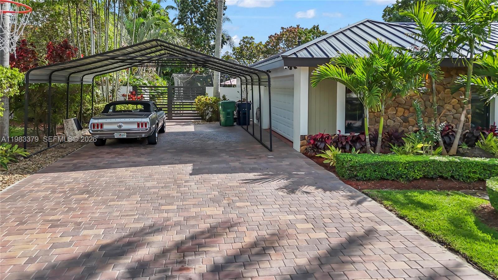 10320 Southwest 139th Street Miami, FL 33176 - Photo 85 of 100 a car parked in front of house with a yard