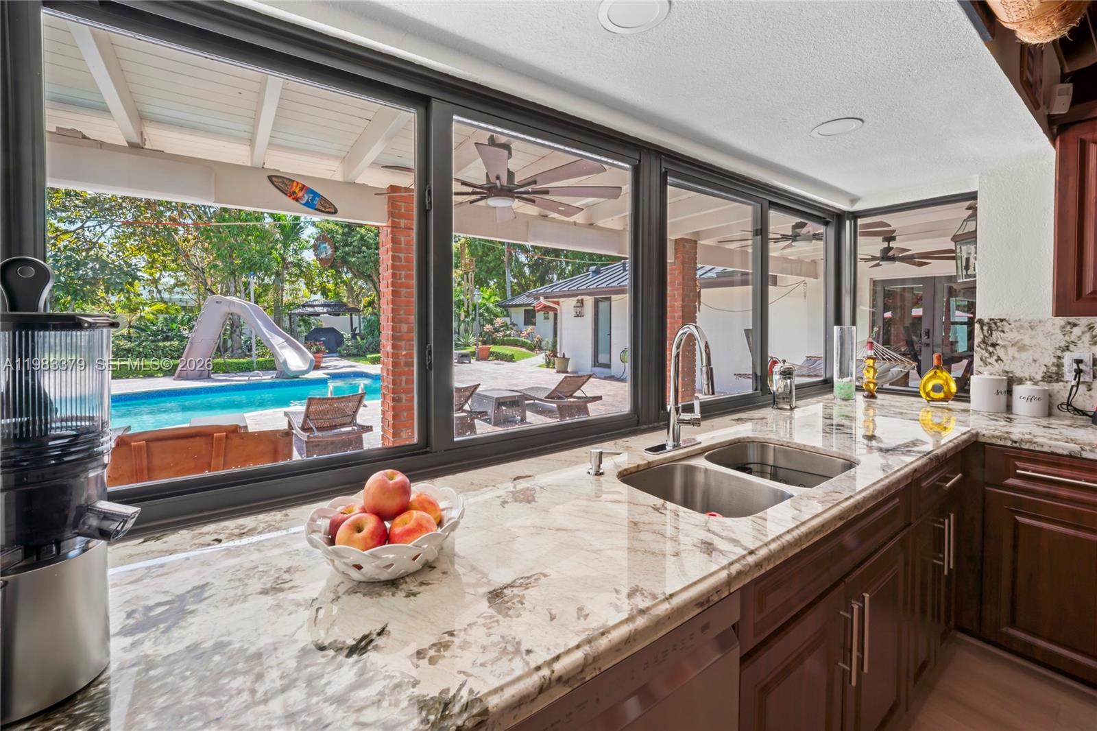 10320 Southwest 139th Street Miami, FL 33176 - Photo 96 of 100 a kitchen with a large window and a sink
