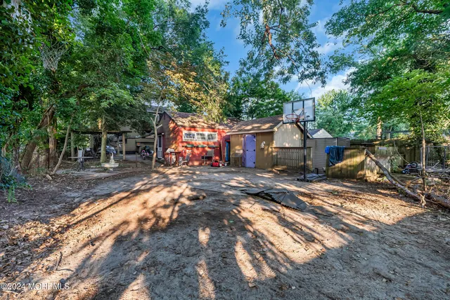 an aerial view of residential houses with outdoor space and trees