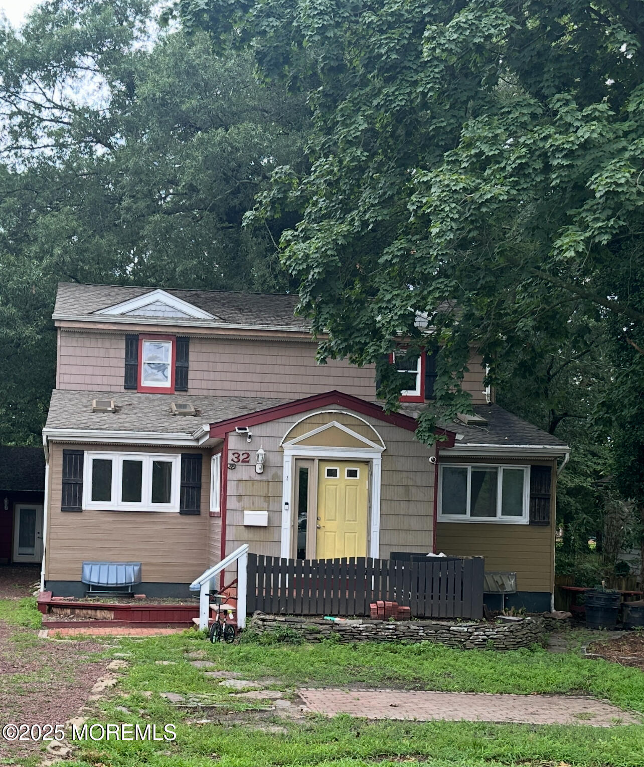 32 Woodrow Street Oakhurst, NJ 07755 - Photo 2 of 19 a front view of a house with a garden