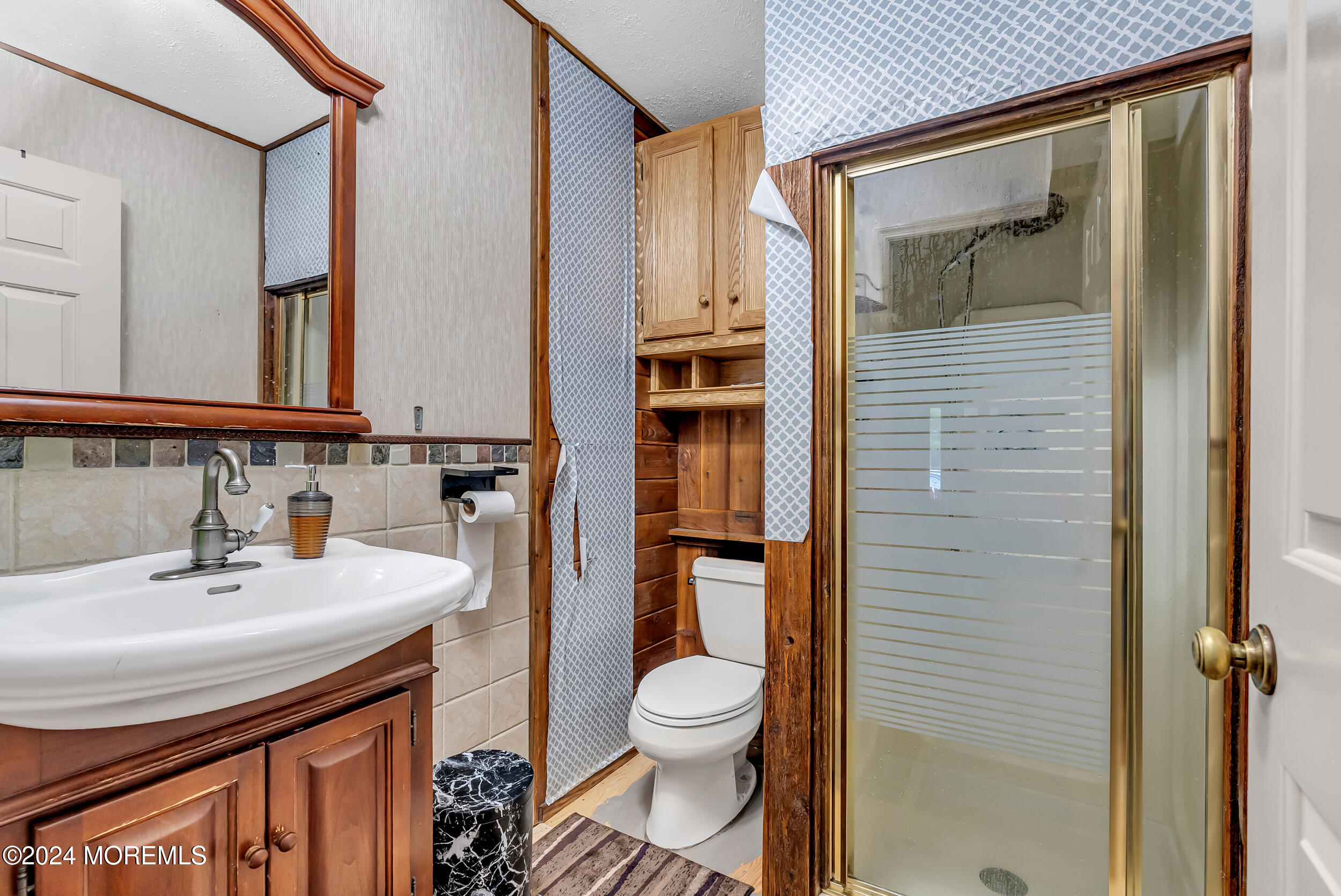 32 Woodrow Street Oakhurst, NJ 07755 - Photo 6 of 19 a bathroom with a toilet a sink and mirror