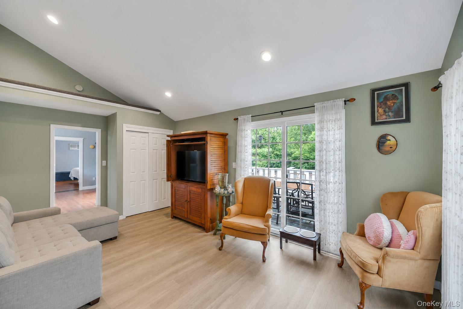 19 Joan Road Bay Shore, NY 11706 - Photo 30 of 50 Vaulted ceilings with recessed lighting over wood-finish flooring