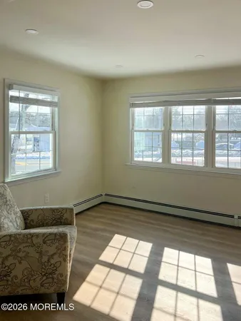a living room with furniture and a floor to ceiling window