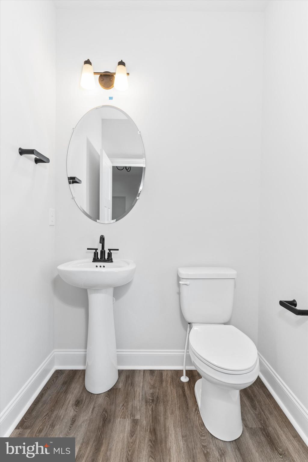 14274 Schooner Run, Unit 83 Ellendale, DE 19941 - Photo 13 of 56 a bathroom with a toilet sink and mirror