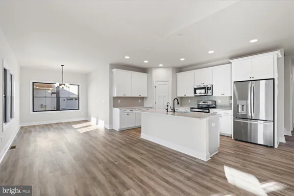 a kitchen with stainless steel appliances a refrigerator sink and stove