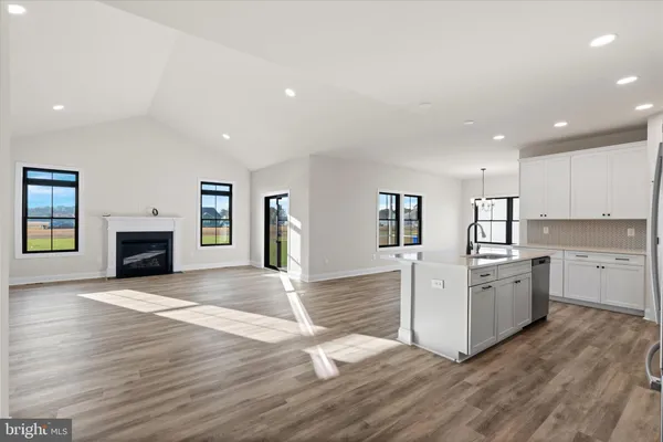 an open kitchen with a sink and a fireplace
