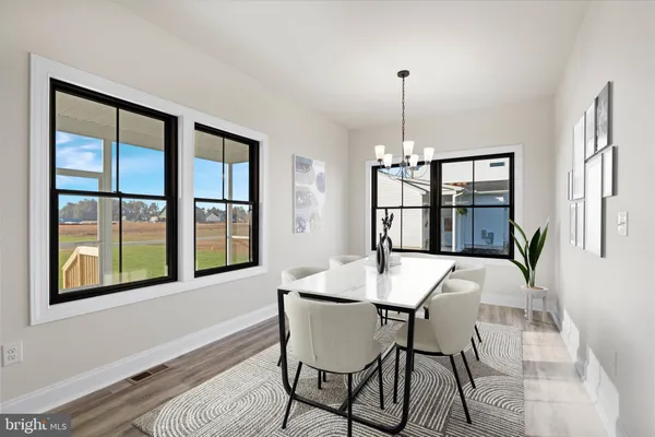 a view of a dining room with furniture window and wooden floor