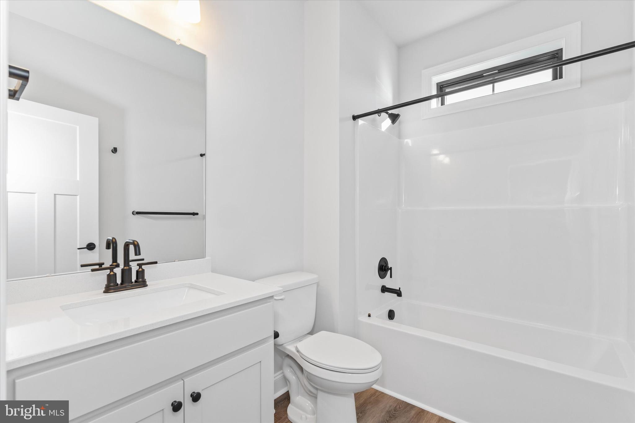 14274 Schooner Run, Unit 83 Ellendale, DE 19941 - Photo 35 of 56 a bathroom with a sink a toilet and a mirror