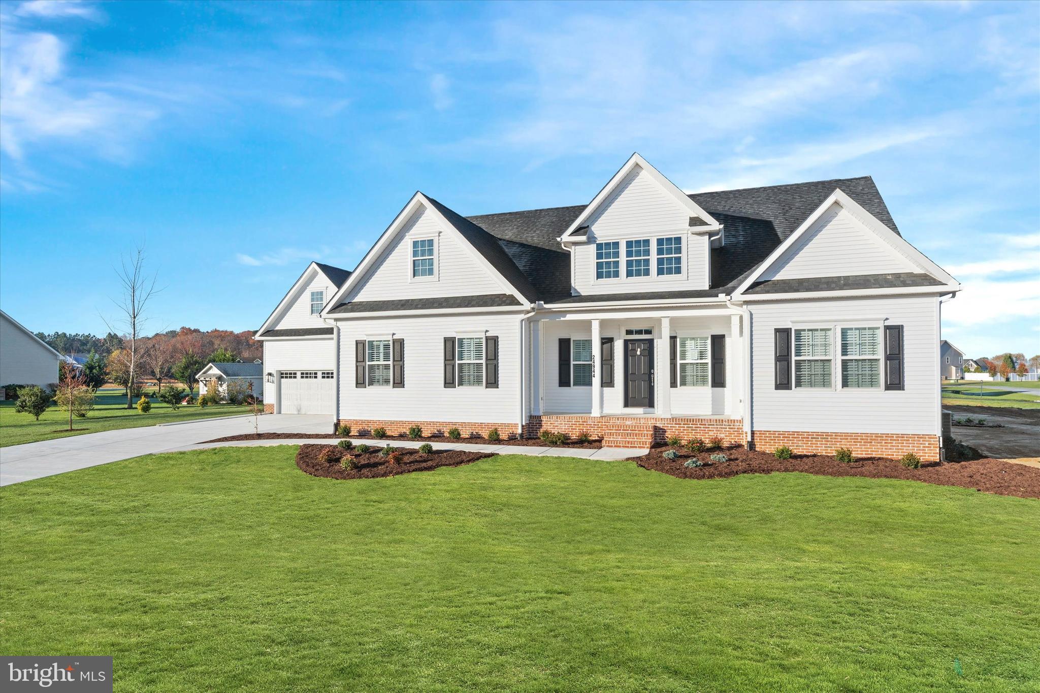 14274 Schooner Run, Unit 83 Ellendale, DE 19941 - Photo 4 of 56 a white house with a big yard and more windows