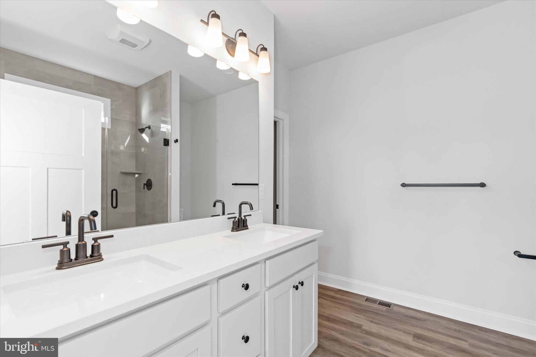 14274 Schooner Run, Unit 83 Ellendale, DE 19941 - Photo 43 of 56 a bathroom with a sink vanity and a mirror
