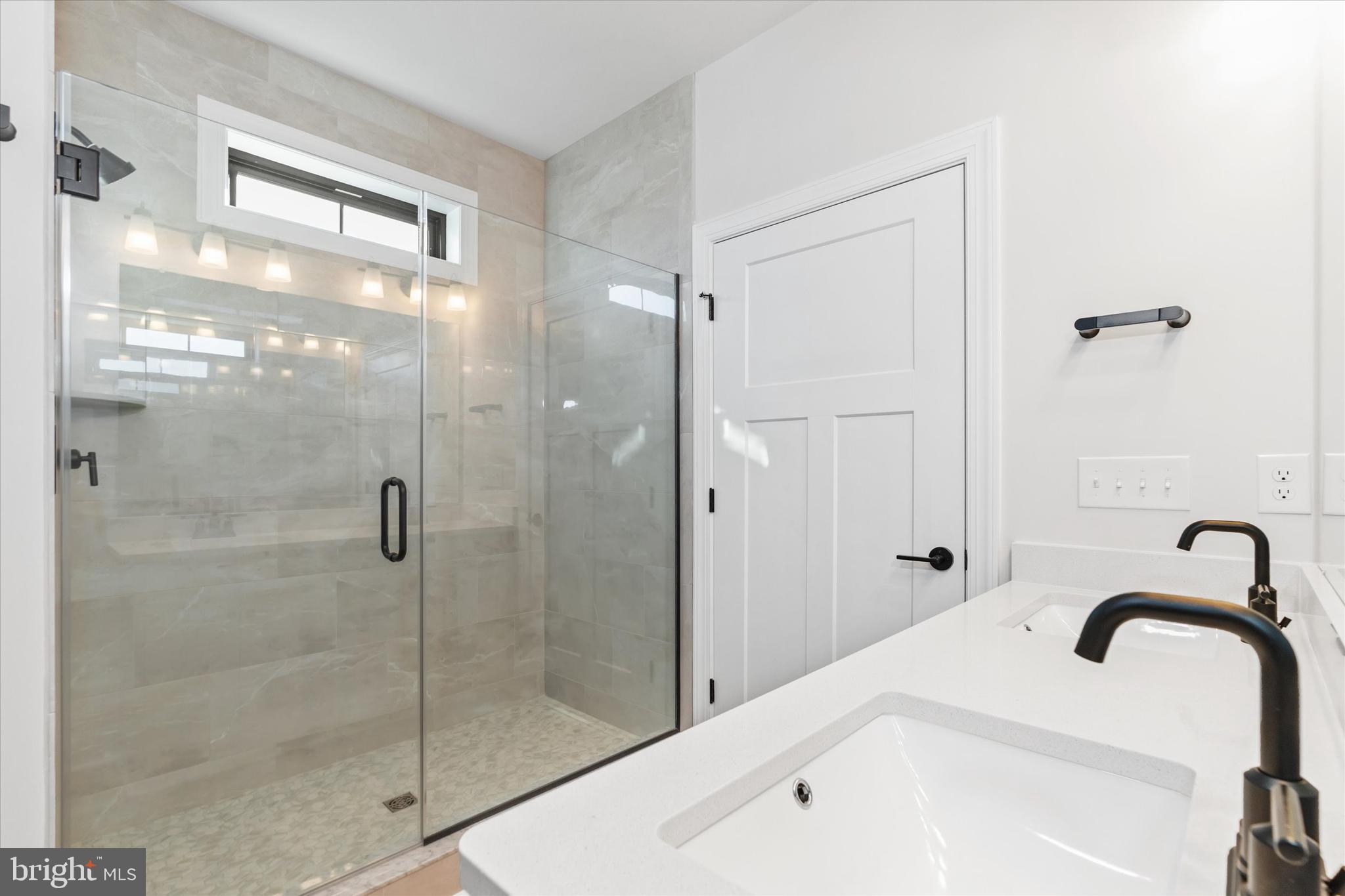 14274 Schooner Run, Unit 83 Ellendale, DE 19941 - Photo 45 of 56 a bathroom with a granite countertop sink a mirror and shower