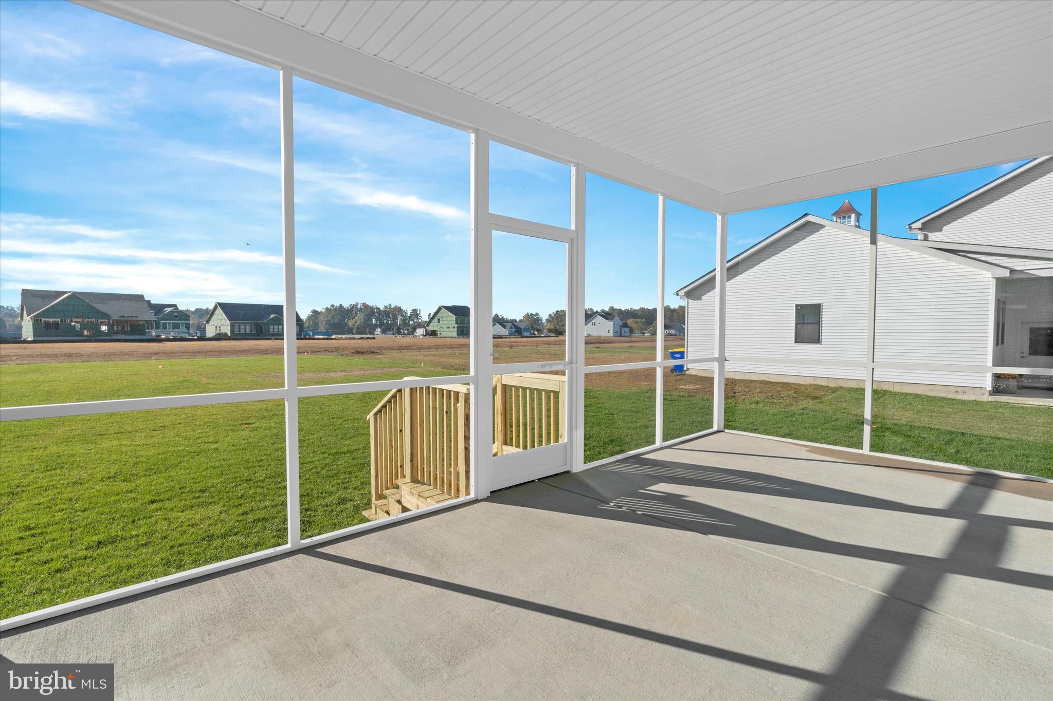 14274 Schooner Run, Unit 83 Ellendale, DE 19941 - Photo 50 of 56 a view of a house with a backyard and a floor to ceiling window