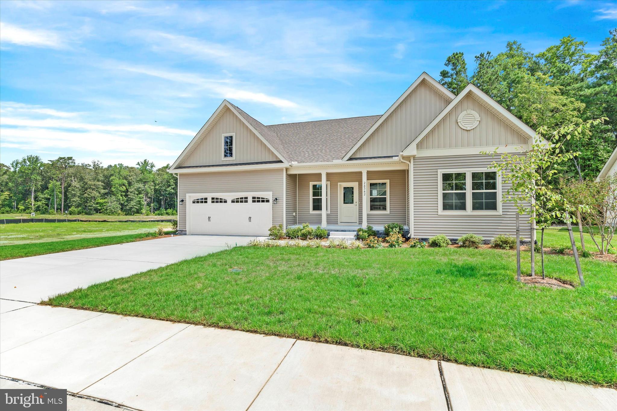 14274 Schooner Run, Unit 83 Ellendale, DE 19941 - Photo 6 of 56 a front view of a house with a yard and garage