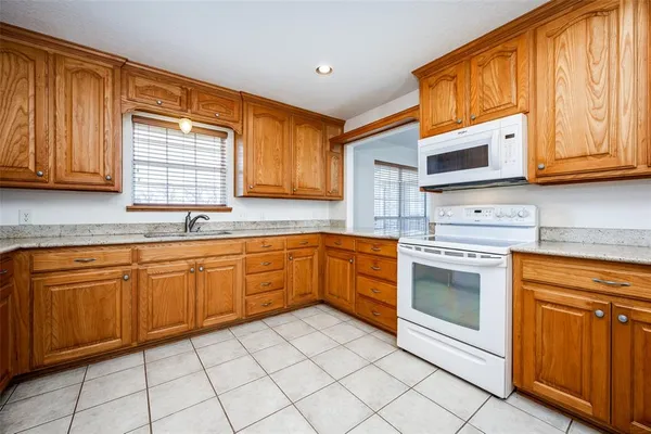 a kitchen with stainless steel appliances granite countertop a sink and cabinets