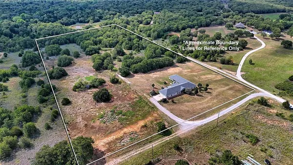 an aerial view of house with a yard