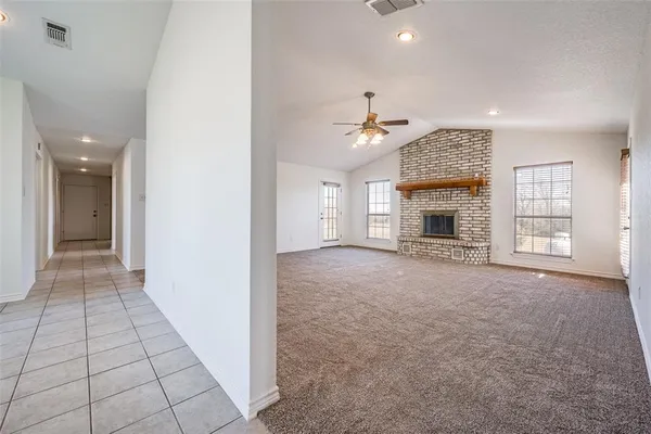 an empty room with closet and a chandelier fan