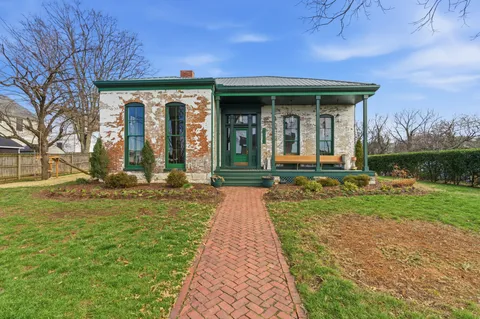 a front view of a house with garden