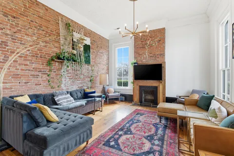 a living room with fireplace furniture and a flat screen tv