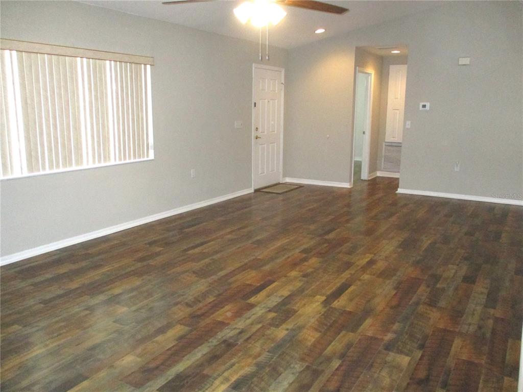 11536 Southwest 140th Loop Dunnellon, FL 34432 - Photo 13 of 75 an empty room with wooden floor and windows