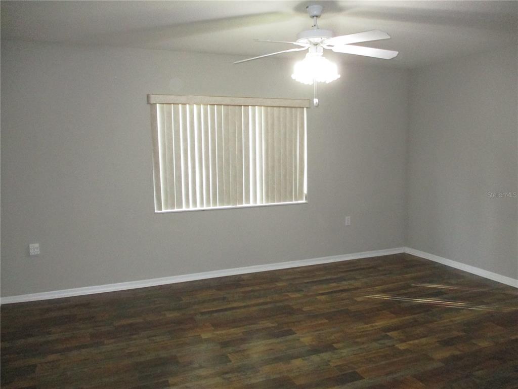 11536 Southwest 140th Loop Dunnellon, FL 34432 - Photo 17 of 75 wooden floor in an empty room with a window