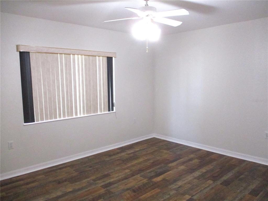 11536 Southwest 140th Loop Dunnellon, FL 34432 - Photo 25 of 75 a view of an empty room with wooden floor and a window