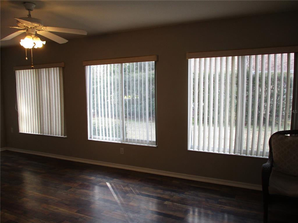 11536 Southwest 140th Loop Dunnellon, FL 34432 - Photo 34 of 75 a view of an empty room with wooden floor and a window