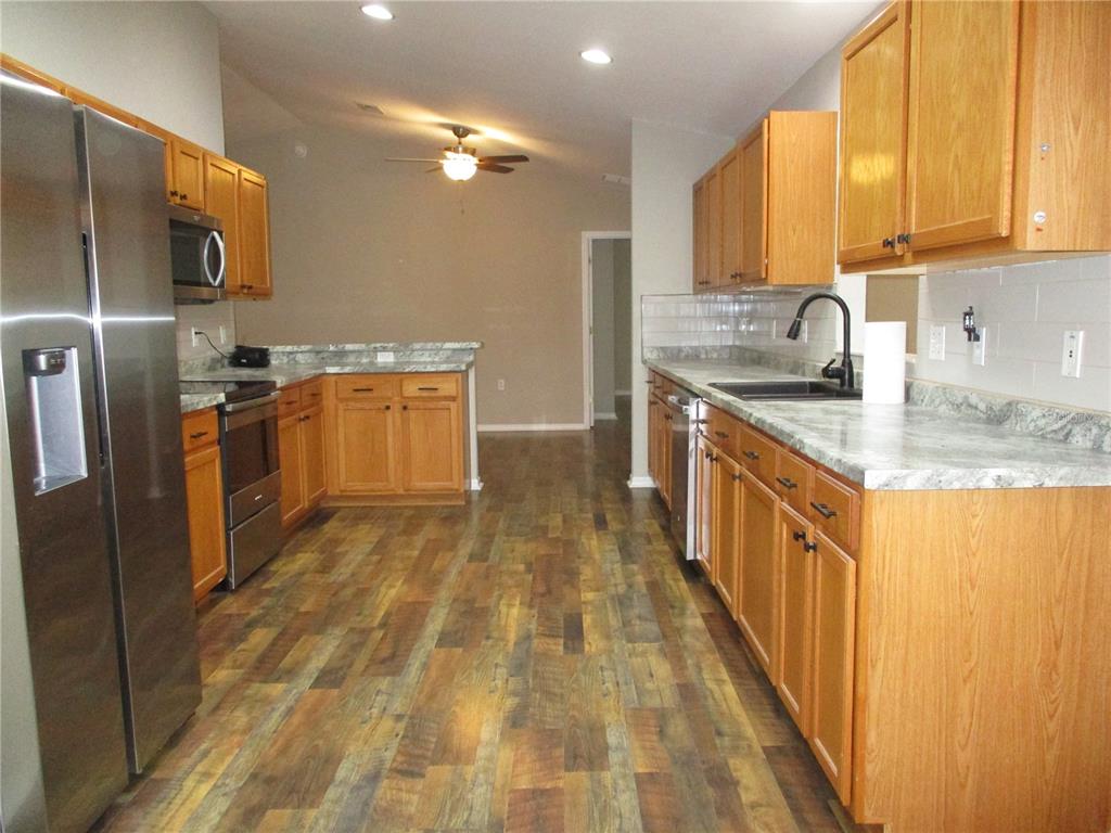 11536 Southwest 140th Loop Dunnellon, FL 34432 - Photo 5 of 75 a kitchen with stainless steel appliances granite countertop a sink a stove and a refrigerator