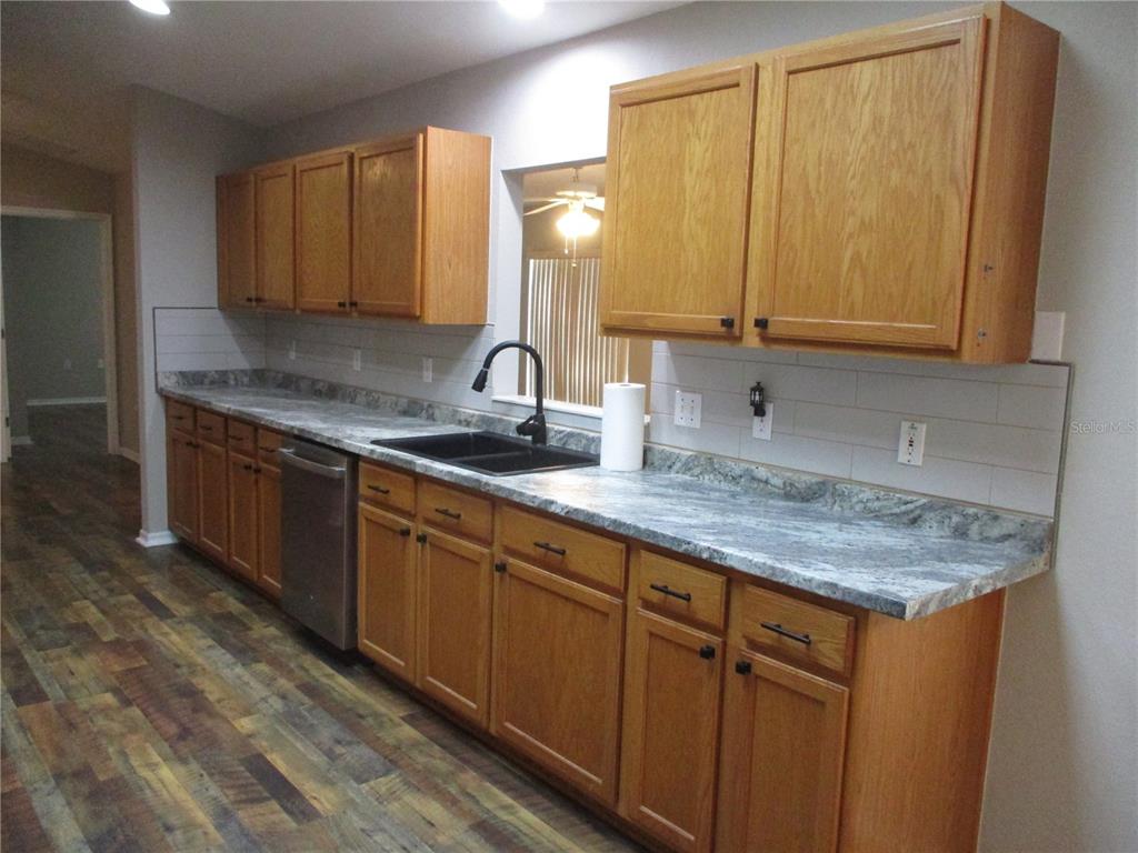 11536 Southwest 140th Loop Dunnellon, FL 34432 - Photo 8 of 75 a kitchen with stainless steel appliances granite countertop a sink stove and cabinets