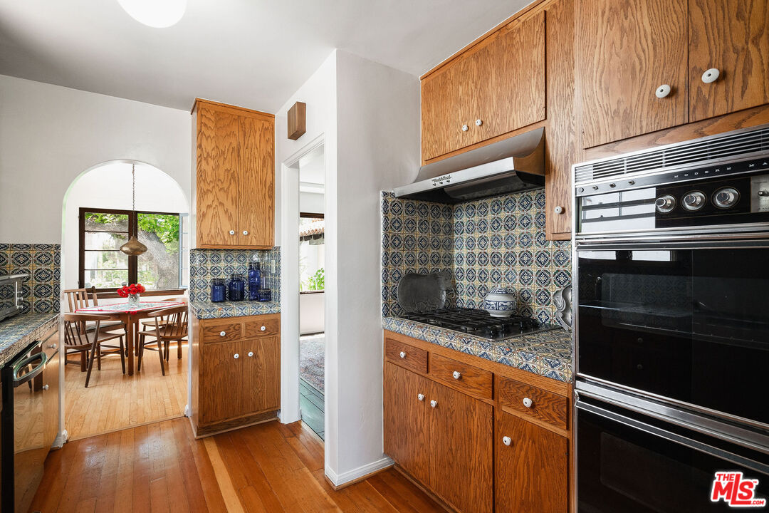 447 9th Street Santa Monica, CA 90402 - Photo 22 of 58 a kitchen with stainless steel appliances granite countertop a stove and cabinets