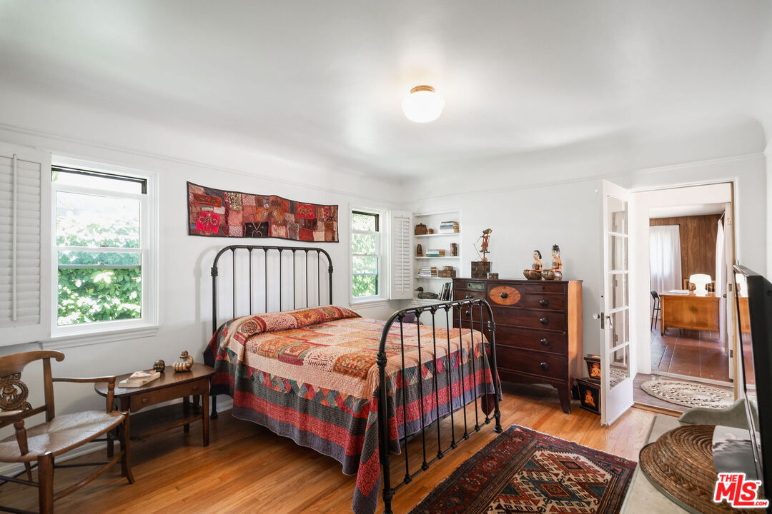 447 9th Street Santa Monica, CA 90402 - Photo 24 of 58 a bedroom with a bed and wooden floor