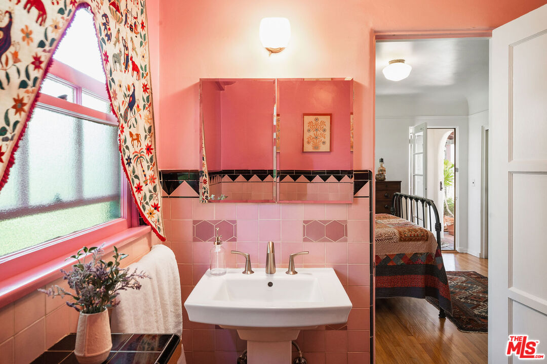 447 9th Street Santa Monica, CA 90402 - Photo 28 of 58 a bathroom with a sink and a mirror