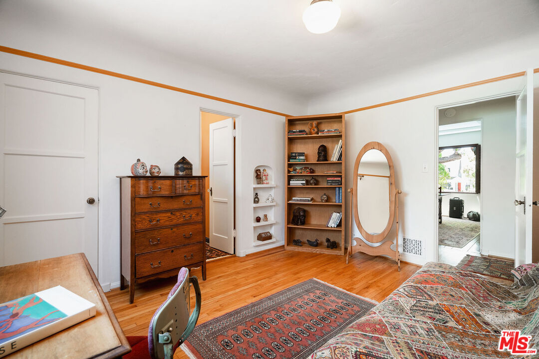 447 9th Street Santa Monica, CA 90402 - Photo 32 of 58 a view of a bedroom with baby bed and workspace