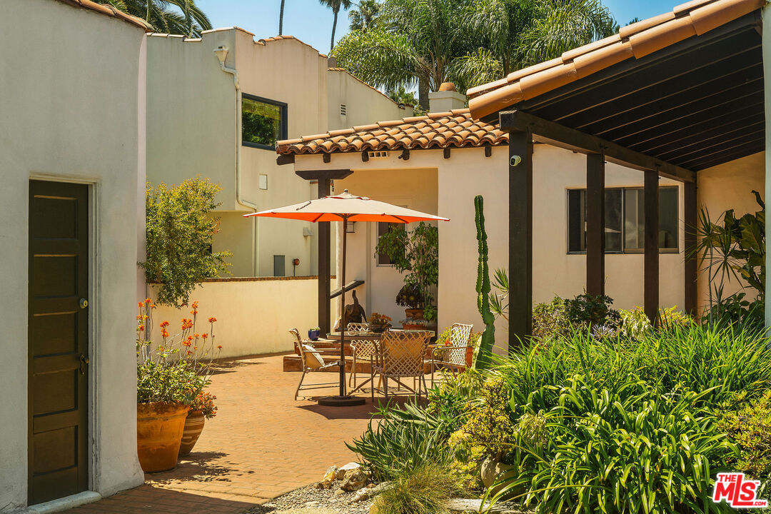 447 9th Street Santa Monica, CA 90402 - Photo 45 of 58 a patio with table and chairs under an umbrella