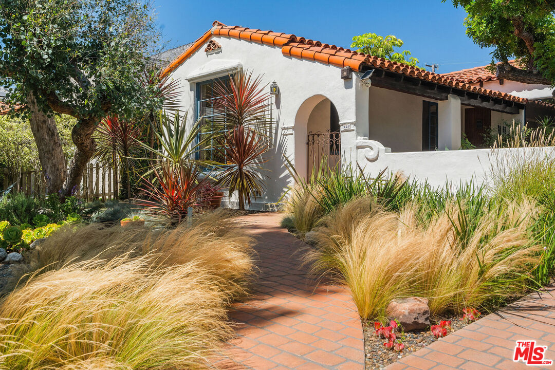 447 9th Street Santa Monica, CA 90402 - Photo 55 of 58 a view of a white house with a large tree and wooden fence