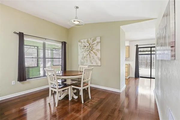 a view of a dining room with furniture and wooden floor