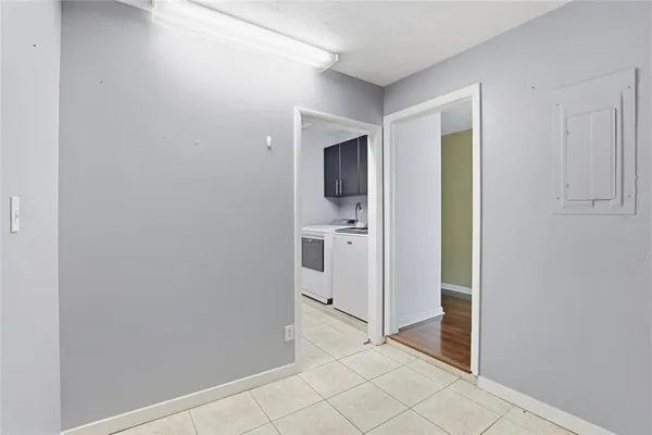a view of a hallway with bathroom and wooden floor