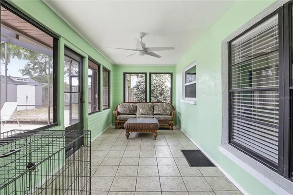 a living room with furniture and a floor to ceiling window