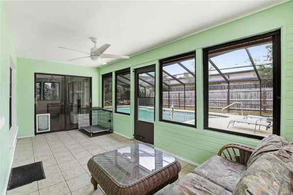 a living room with furniture and a floor to ceiling window