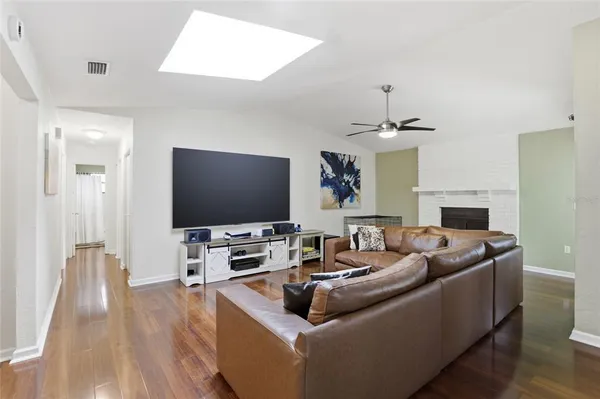 a living room with fireplace furniture and a flat screen tv