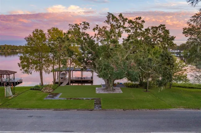 a view of a house with a yard and a garden