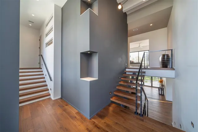 a view of entryway and hall with wooden floor