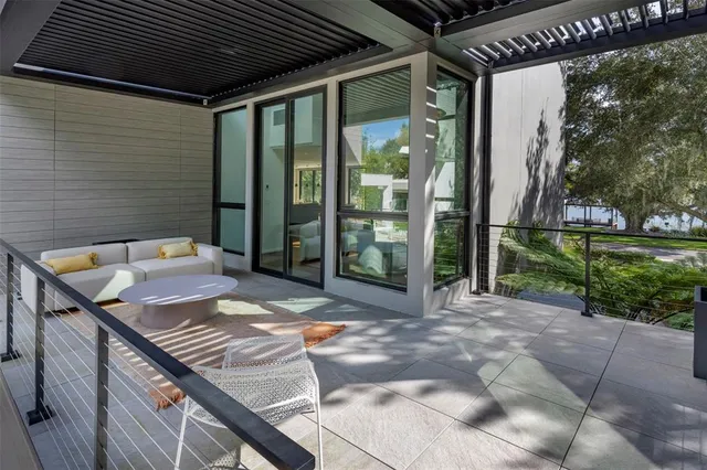 a backyard of a house with fountain table and chairs