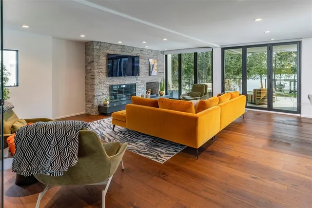 a living room with furniture and large windows
