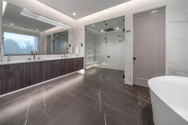 a large bathroom with a large mirror vanity and toilet